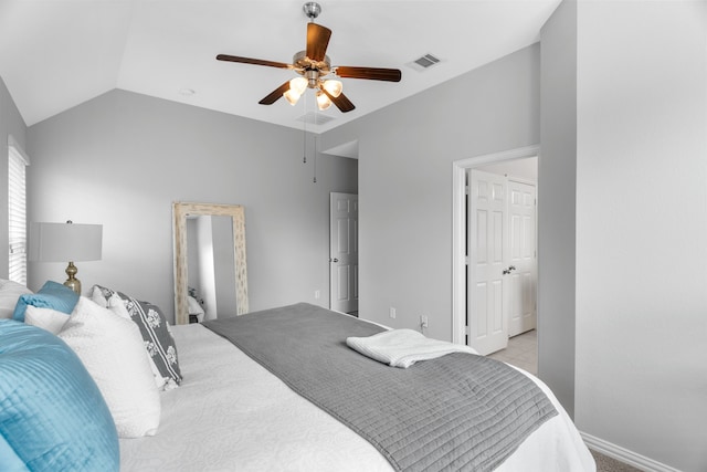 bedroom featuring ceiling fan, light tile patterned floors, and vaulted ceiling