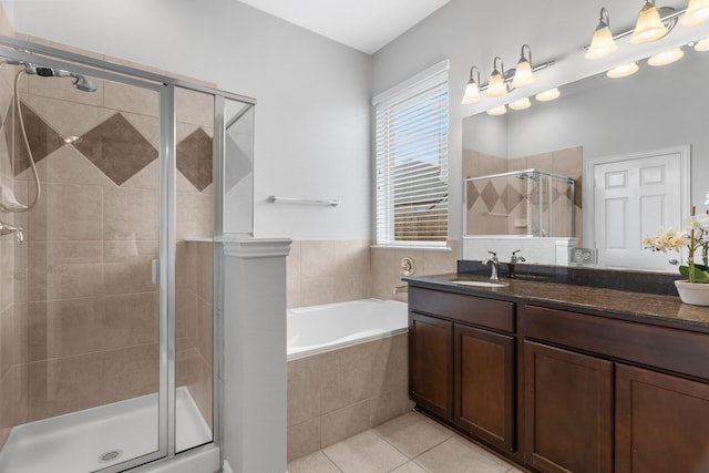 bathroom with tile patterned flooring, vanity, and separate shower and tub