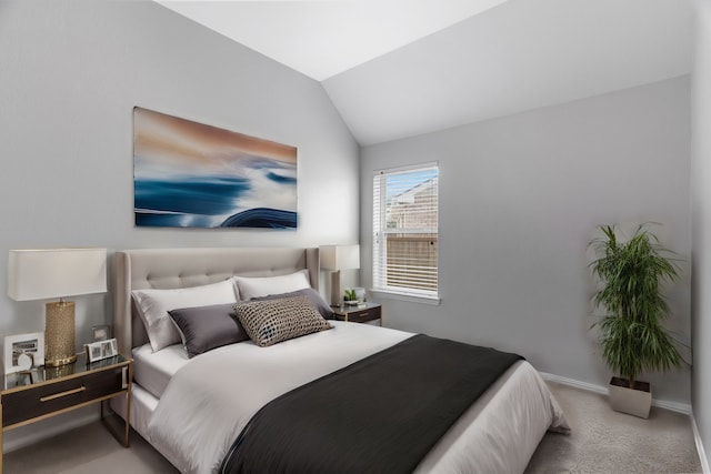 bedroom with light colored carpet and lofted ceiling