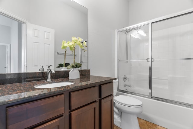 full bathroom featuring tile patterned flooring, vanity, enclosed tub / shower combo, and toilet