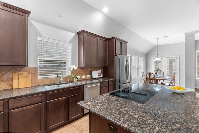 kitchen with decorative backsplash, appliances with stainless steel finishes, dark brown cabinetry, sink, and lofted ceiling