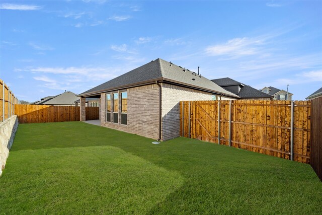 rear view of property with a yard