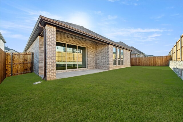 rear view of house with a lawn