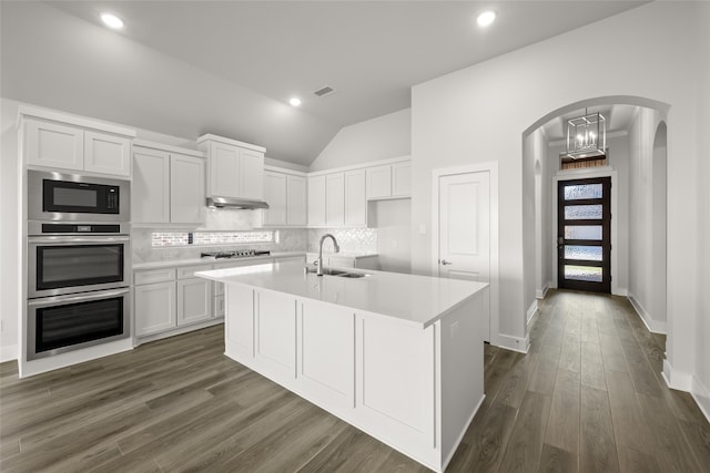 kitchen with white cabinets, appliances with stainless steel finishes, sink, and an island with sink