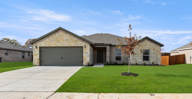 view of front of house with a garage and a front lawn