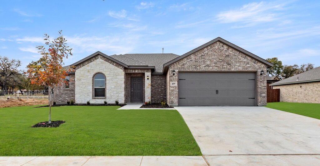 ranch-style house with a front lawn and a garage