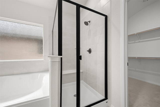 bathroom with shower with separate bathtub