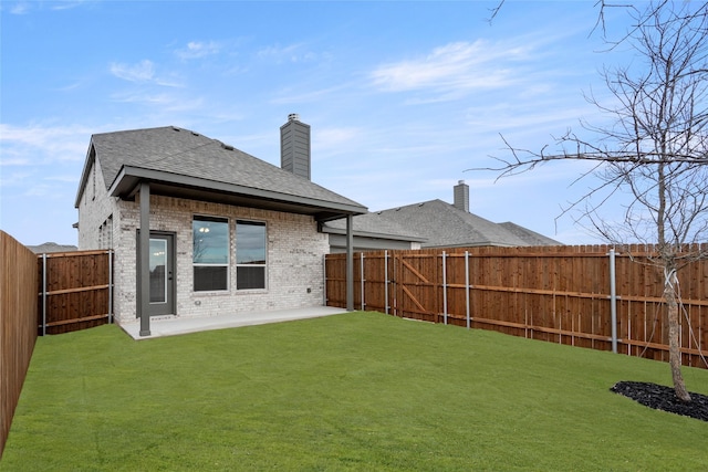 back of property featuring a patio area and a yard