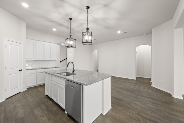 kitchen featuring white cabinets, sink, hanging light fixtures, stainless steel dishwasher, and a center island with sink