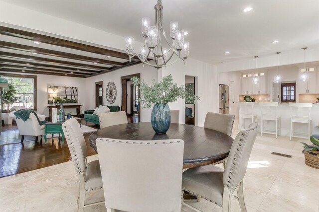 dining room with beam ceiling and light hardwood / wood-style floors