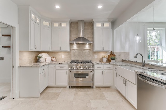 415 Featherston St, Cleburne, TX 76033 - kitchen featuring wall chimney range hood, stainless steel appliances, backsplash, a sink, and white cabinetry