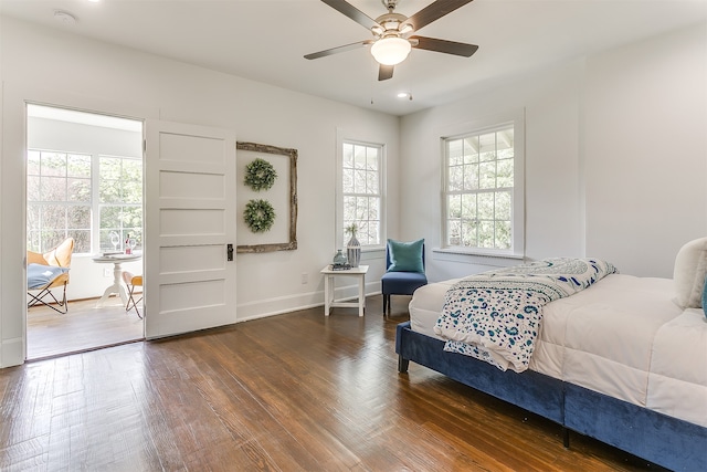 bedroom with ceiling fan and dark wood-type flooring