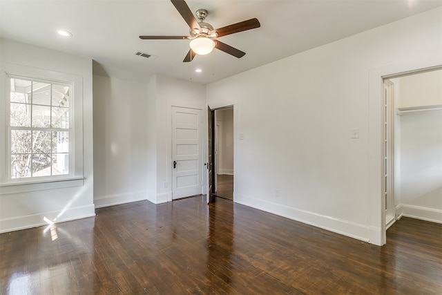 unfurnished bedroom featuring ceiling fan and dark hardwood / wood-style floors