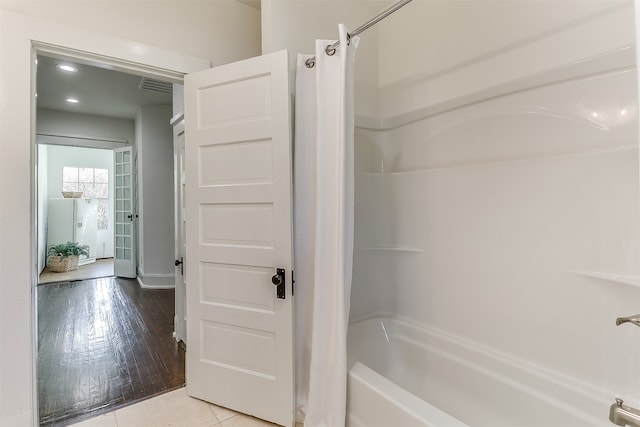 bathroom featuring shower / tub combo and hardwood / wood-style flooring