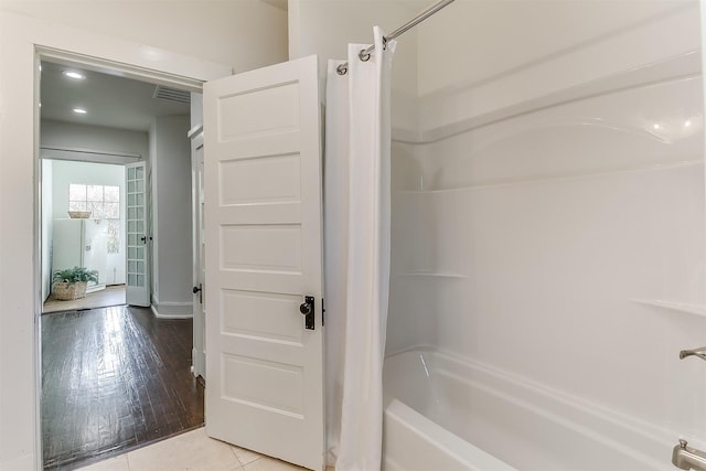 415 Featherston St, Cleburne, TX 76033 - bathroom featuring  shower combination, recessed lighting, and baseboards