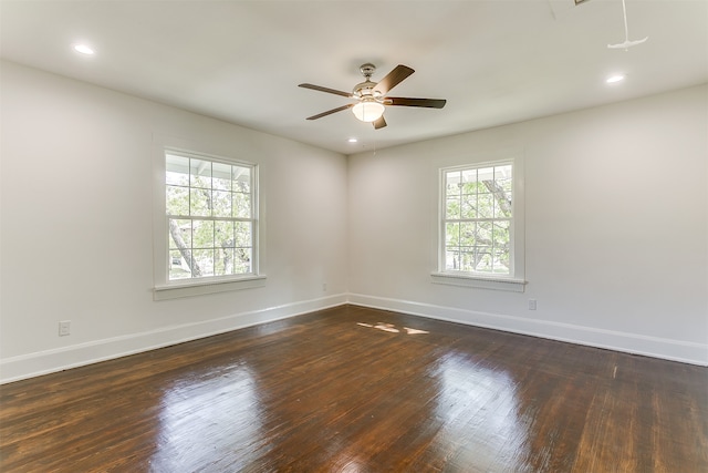 spare room featuring ceiling fan and dark hardwood / wood-style flooring