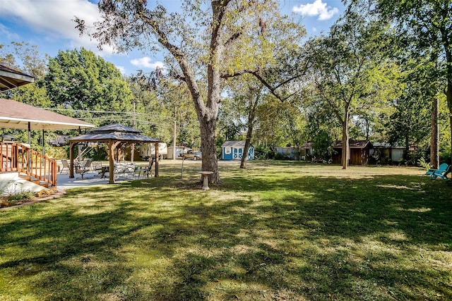 view of yard with a gazebo and a storage shed