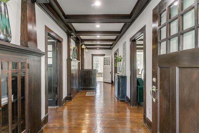 corridor with beam ceiling, coffered ceiling, and dark hardwood / wood-style floors