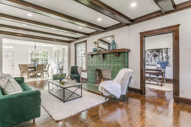 415 Featherston St, Cleburne, TX 76033 - living area with baseboards, wood finished floors, a fireplace, beam ceiling, and a chandelier