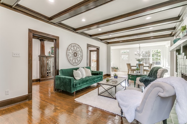 living room featuring beamed ceiling, dark hardwood / wood-style floors, a chandelier, and ornamental molding