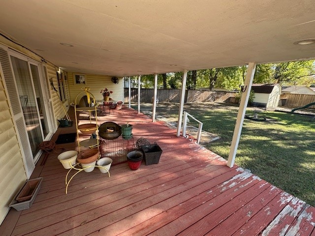 deck featuring a yard and a storage shed