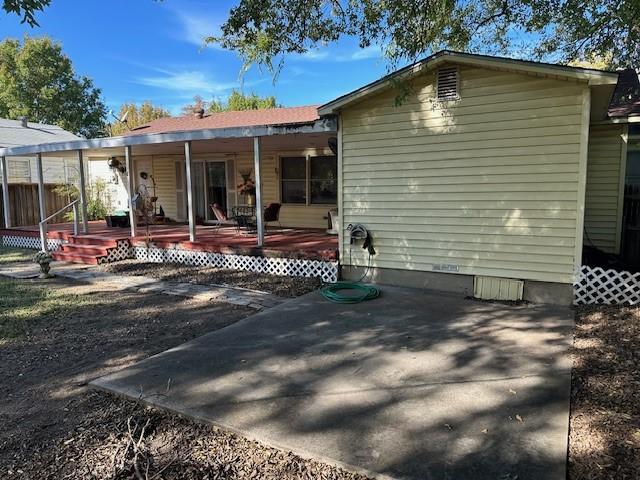 back of house featuring a porch