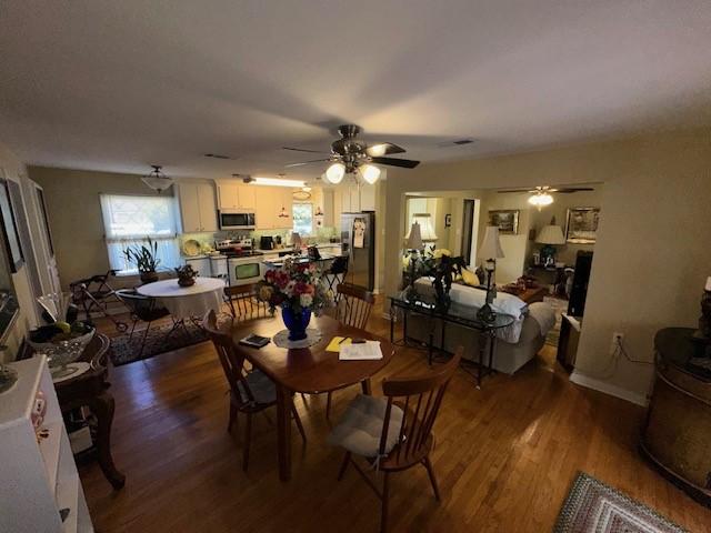 dining space featuring hardwood / wood-style flooring and ceiling fan