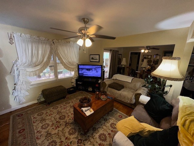 living room featuring hardwood / wood-style floors and ceiling fan