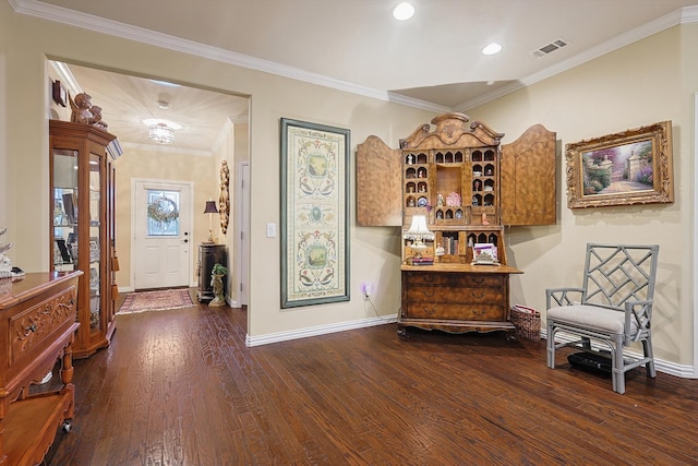 living area with wood-type flooring and ornamental molding