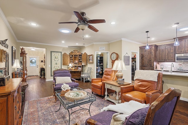 living room with sink, ceiling fan, dark hardwood / wood-style flooring, and crown molding