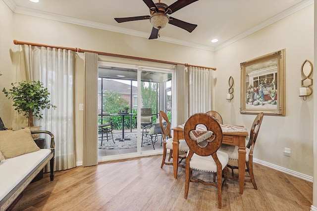 dining space with ceiling fan, light wood-type flooring, and ornamental molding