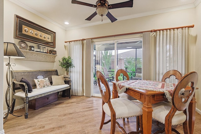 dining area with ceiling fan, ornamental molding, and light wood-type flooring