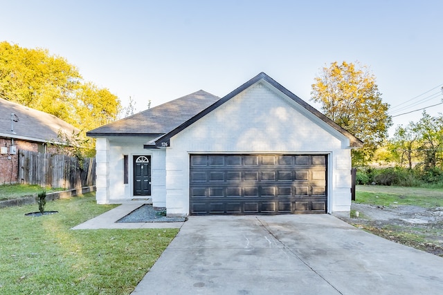 view of front of house featuring a garage and a front lawn