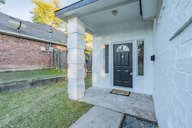 entrance to property with a yard