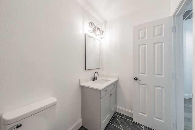 bathroom featuring vanity and toilet