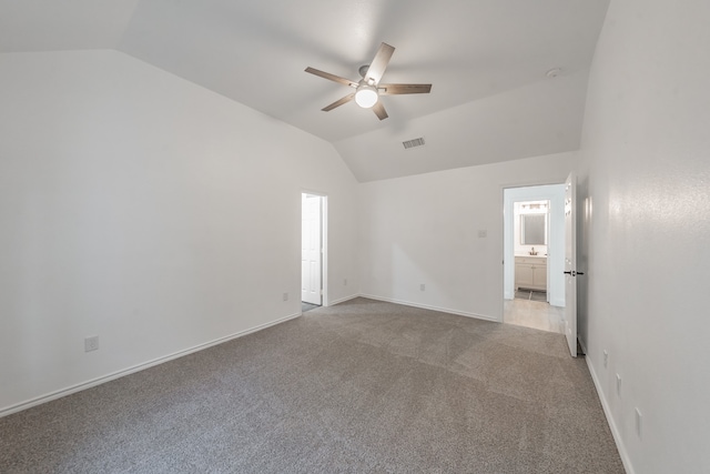 unfurnished room with ceiling fan, light carpet, and vaulted ceiling