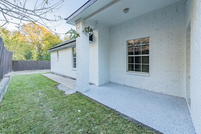 exterior space featuring a lawn and a patio