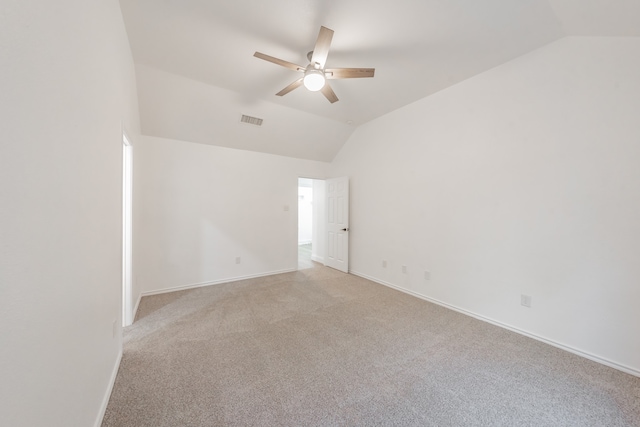 spare room with ceiling fan, light colored carpet, and lofted ceiling