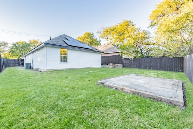 view of yard with a patio and central air condition unit