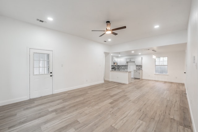 unfurnished living room featuring ceiling fan and light hardwood / wood-style floors