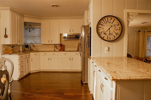 kitchen featuring white cabinets, dark hardwood / wood-style floors, and light stone counters