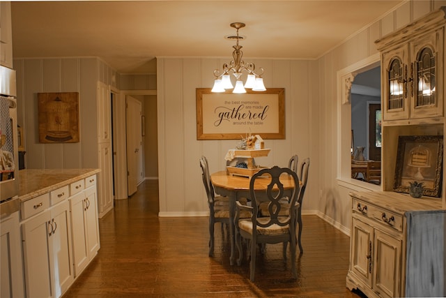 dining space featuring dark hardwood / wood-style floors and ornamental molding