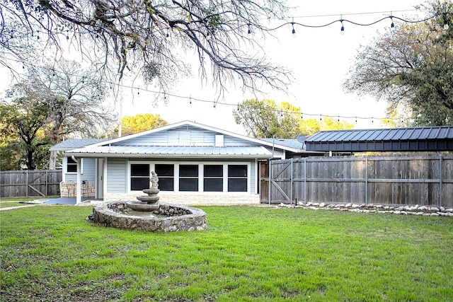 rear view of house with a lawn