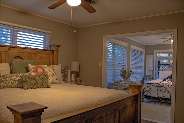 bedroom featuring carpet floors, ceiling fan, and ornamental molding