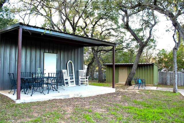 view of yard featuring a patio and an outdoor structure