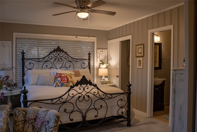 bedroom with ceiling fan, carpet floors, crown molding, and connected bathroom