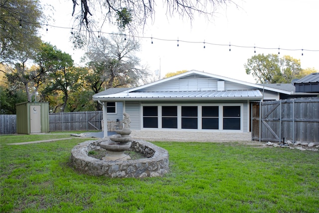 back of property featuring a lawn