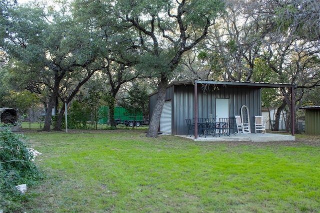 view of yard featuring a patio area and an outdoor structure