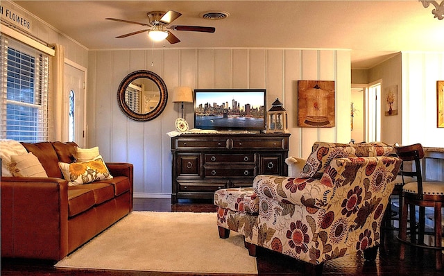 living room with crown molding, ceiling fan, and dark hardwood / wood-style flooring