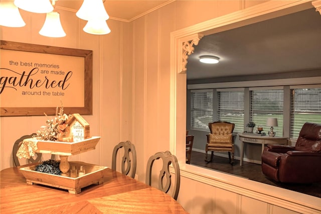 dining space featuring crown molding